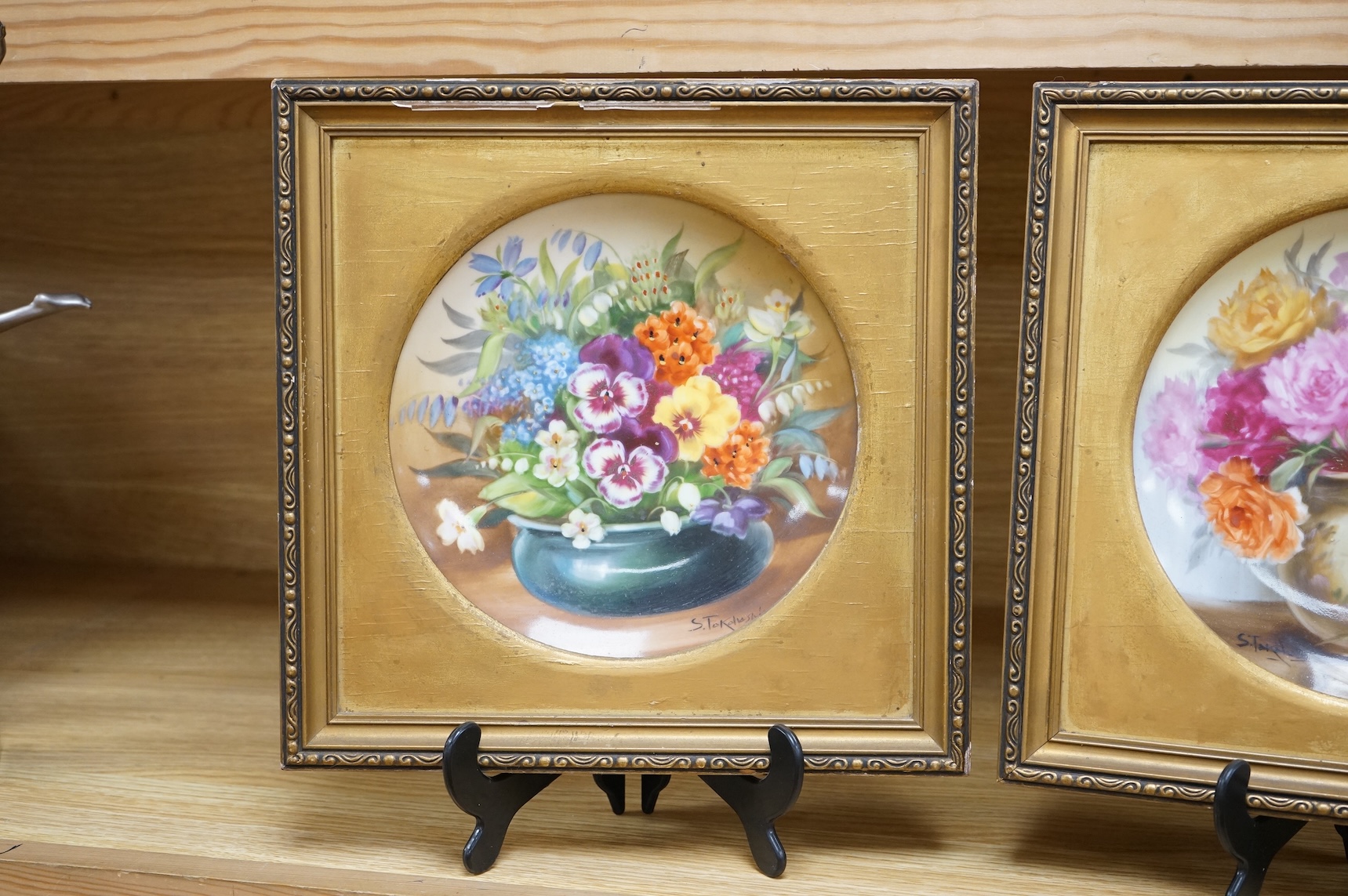 A pair of Noritake floral plates, signed S. Tokohashi, frames in gilt mounts and frames, plates 18.5cm diameter.